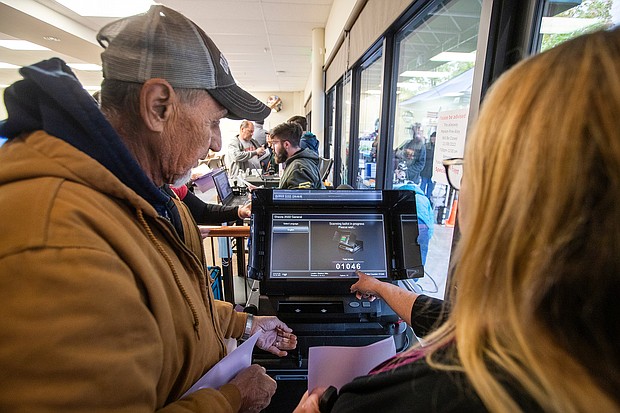 Shasta County resident Teresa Romero, 64, right, points out to her husband Charles, 68, how the number increased by one on a Dominion voting machine to indicate that his ballot was successfully scanned after being entered into the machine at the Shasta County Clerk & Elections office in Redding, California.
Mandatory Credit:	Mel Melcon/Los Angeles Times/Getty Images