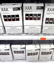 Juul Labs is paying $462 million to six US states and DC in the largest multi-state settlement yet for the troubled company. Juul e-cigarettes are displayed here for sale in 2022 in Los Angeles.
Mandatory Credit:	Mario Tama/Getty Images