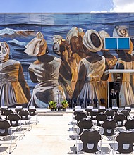 The mural painted on the Julia C. Hester House Wellness Center recreated a painting, “The Stream Crosses the Path,” by late Houston artist John Biggers.