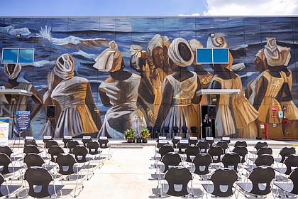 The mural painted on the Julia C. Hester House Wellness Center recreated a painting, “The Stream Crosses the Path,” by late Houston artist John Biggers.