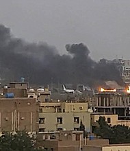 Smoke rises from the tarmac of Khartoum International Airport as a fire burns, in Khartoum, Sudan, Monday, April 17.
Mandatory Credit:	Abdullah Abdel Moneim/Reuters