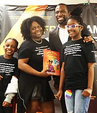 Mayor Levar M. Stoney stands with Amber Coleman of York County, center, who is a nurse anesthetist at Riverside Hospital in Newport News, during the African-American Book Festival at Richmond Diversity Center on Saturday, April 15. Ms. Coleman is the author of a children’s book, “Amber Dreams of Anesthesia,” which is about how she became a nurse anesthetist. The author’s children are children Dilan, 8, left, and Chole Coleman, 10. During the event, Mayor Stoney shared his relationship with reading, and how his grandmother and father were instrumental in making sure that he became a stronger reader.