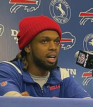 Buffalo Bills safety Damar Hamlin speaks to reporters Tuesday at the NFL football team’s facility in Orchard Park, N.Y. He said he plans to resume his football career after being cleared to play more than four months after going into cardiac arrest and needing to be resuscitated on the field during a game in Cincinnati.