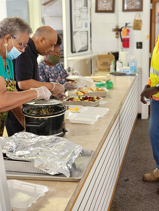 Elaine Miller, Luther A. Brown Jr. and Josephine S. Myers on the serving line at Swansboro Baptist Church on Midlothian Turnpike.