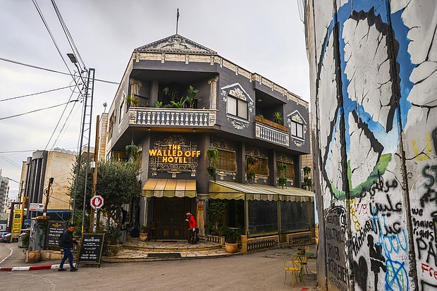 A view of Banksy's 'The Walled Off Hotel' next to the Israeli separation barrier in Israeli-occupied Bethlehem on December 28, 2022.
Mandatory Credit:	Beata Zawrzel/NurPhoto/Getty Images