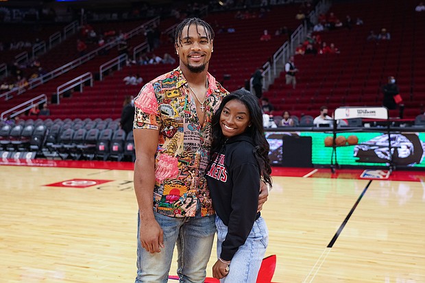 Simone Biles and Jonathan Owens attend a game between the Houston Rockets and the Los Angeles Lakers on December 28, 2021, in Houston, Texas. Biles and NFL player Jonathan Owens are now married.
Mandatory Credit:	Carmen Mandato/Getty Images/FILE