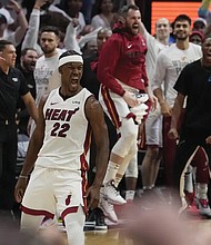 Miami Heat forward Jimmy Butler (22) celebrates Monday after scoring during the second half of Game 4 in the first round NBA basketball playoff series against the Milwaukee Bucks in Miami. The Heat defeated the Bucks 119-114. Jimmy Butler scored 56 points.