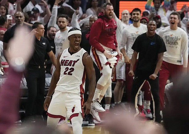 Miami Heat forward Jimmy Butler (22) celebrates Monday after scoring during the second half of Game 4 in the first round NBA basketball playoff series against the Milwaukee Bucks in Miami. The Heat defeated the Bucks 119-114. Jimmy Butler scored 56 points.