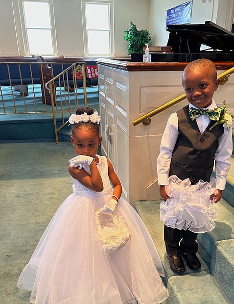 Flower girl Sidney Drew, 5, and ring bearer Shomari Kearney, 4, brought smiles before and after they walked down the aisle at Richmond’s Second Baptist Church, 1400 Idlewood Ave. on April 23. The two youngsters, whose fathers are Alvin Drew and Nathaniel Kearney, participated in the wedding of Joseph W. and Apryl (Pecht) Wimbush.