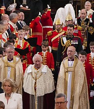 pg. 4 King Charles III followed by his Page of Honour Prince George during his coronation ceremony in Westminster Abbey, London. UK, on May 6, 2023.
