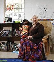 Aminata Umoja of Lithonia, Ga., poses in March for a portrait with a puppet named Swahili in a classroom at the Kilombo Academic and Cultural Institute in Decatur, Ga. Ms. Umoja is an educator and the founder of the Kilombo Academic and Cultural Institute.