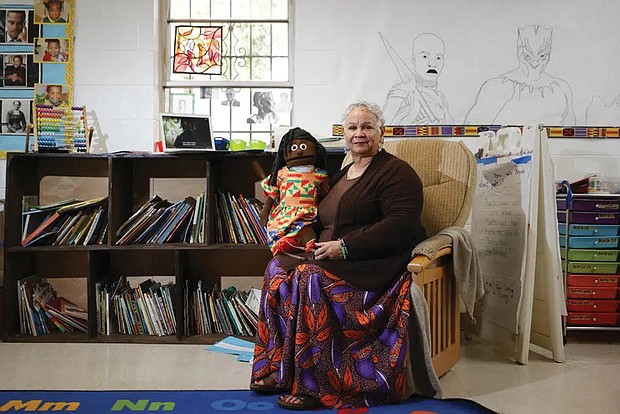 Aminata Umoja of Lithonia, Ga., poses in March for a portrait with a puppet named Swahili in a classroom at the Kilombo Academic and Cultural Institute in Decatur, Ga. Ms. Umoja is an educator and the founder of the Kilombo Academic and Cultural Institute.
