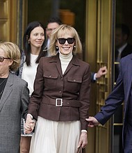 E. Jean Carroll, center, walks out of Manhattan federal court, Tuesday, in New York. A jury found Donald Trump liable for sexually abusing the advice columnist in 1996, awarding her $5 million in a judgment that could haunt the former president as he campaigns to regain the White House.