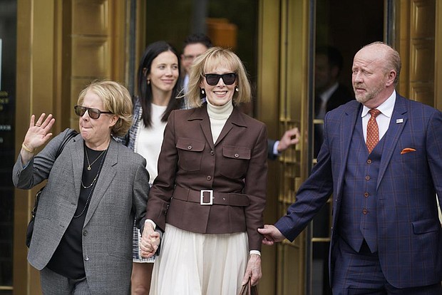 E. Jean Carroll, center, walks out of Manhattan federal court, Tuesday, in New York. A jury found Donald Trump liable for sexually abusing the advice columnist in 1996, awarding her $5 million in a judgment that could haunt the former president as he campaigns to regain the White House.