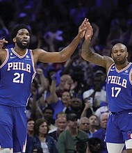 The Philadelphia 76ers’ Joe Embiid (right) is this year’s winner in a close race with Denver’s Nikola Jokic, who had won the two previous MVPs with Embiid as runner-up. Embiid and P.J. Tucker celebrate Sunday during overtime of Game 4 in an NBA basketball Eastern Conference semifinals playoff series against the Boston Celtics in Philadelphia.