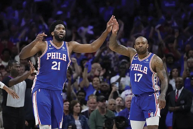 The Philadelphia 76ers’ Joe Embiid (right) is this year’s winner in a close race with Denver’s Nikola Jokic, who had won the two previous MVPs with Embiid as runner-up. Embiid and P.J. Tucker celebrate Sunday during overtime of Game 4 in an NBA basketball Eastern Conference semifinals playoff series against the Boston Celtics in Philadelphia.