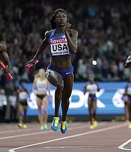 Tori Bowie, center, anchored the U.S. team to gold in the women’s 4x100m relay final during the 2017 World Athletics Championships in London. At left is Britain’s Daryll Neita, who took the silver.