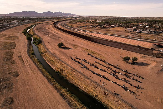 Migrants stand near the border wall after crossing the Rio Bravo river with the intention of turning themselves in to the U.S. Border Patrol agents, as seen from Ciudad Juarez, Mexico, May 9.
Mandatory Credit:	Jose Luis Gonzalez/Reuters
