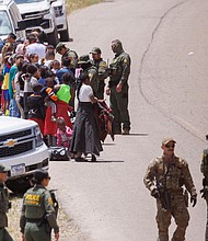 US border patrol personnel organize a group of families near San Diego, California, on Tuesday.
Mandatory Credit:	Mike Blake/Reuters