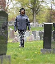 Debra Long walks in April 2023 near the tombstone of her son, Randy Long, in Poughkeepsie, N.Y. An AP examination of data from 23 states shows that Black people are disproportionately denied aid from programs that reimburse victims of violent crime.