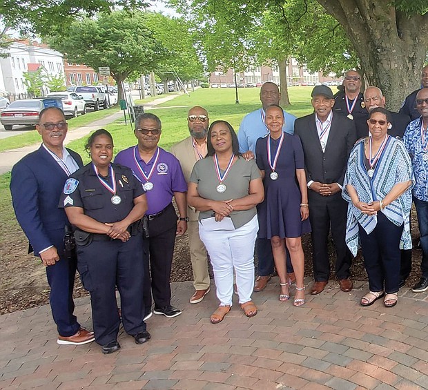 Current and retired Richmond Police officers, including Henrico Police Chief Eric English, join Acting Richmond Police Chief Rick Edwards, right, on Sunday, May 7, in commemorating the hiring of Richmond’s first black officers 77 years ago. This annual ceremony sponsored by Engine Co. #9 and Associates was held at the Virginia Historic Marker at Leigh Street and Brook Road near the site of the precinct where the officers were first assigned. The marker reads, “On 1 May 1946, Richmond’s first professional African American police officers were hired and assigned to the First Precinct at Smith and Marshall Streets. They were Howard T. Braxton, Doctor P. Day, Frank S. Randolph, and John W. Vann. On 16 December 1949, Ruth B. Blair became the first professional African American female police officer hired and assigned to the Juvenile Division. On 18 July 1964, Sergeant Randolph was promoted to Detective Lieutenant. While challenged by segregated conditions and discriminatory practices, their perseverance created an inspiring legacy.”