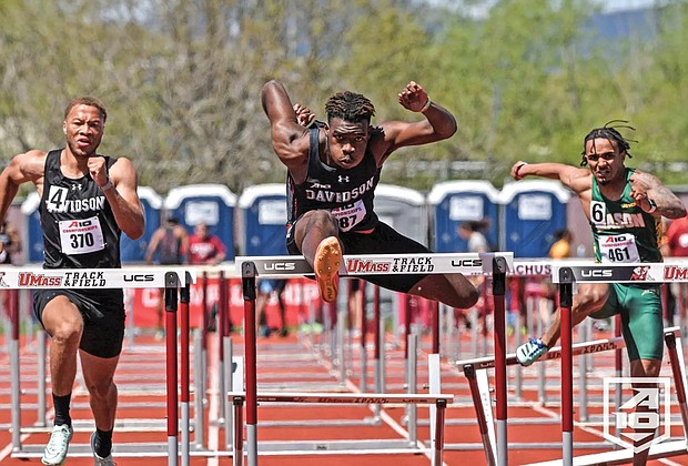 Jayden Smith hurdles in the lead.