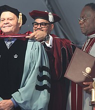 Virginia Union University’s president, Dr. Hakim J. Lucas places an honorary doctoral hood over the head of Dr. John W. Kinney in conferring his honorary doctor of divinity degree for the impact he has had on theological education at VUU for more than 35 years. Assisting with the hooding ceremony Saturday is Dr. W. Franklyn Richardson VUU board president.