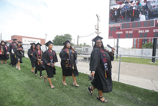 Octavia Davis, 32, above, of Alexandria walks with members of her VUU Class of 2023 during the 124th commencement exercises at VUU’s Hovey Stadium. Ms. Davis is a communications major with a focus in public relations.