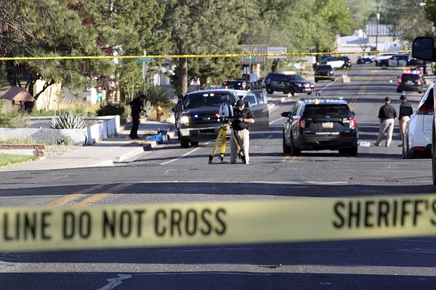 Investigators work along a residential street following a deadly shooting on May 15 in Farmington, N.M.  A 98-year-old woman and her 73-year-old daughter were among the three people killed.
Mandatory Credit:	Susan Montoya Bryan/AP