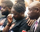 The mother of Irvo Otieno, Caroline Ouko, center, wipes a tear as his brother, Leon Ochieng, left, consoles his mother while Wednesday they are seated with Attorney Benjamin Crump during the Justice for Irvo Otieno Town Hall at Virginia Union University’s Claude G. Perkins Living & Learning Center.