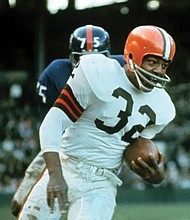 Jimmy Brown (32), running back for the Cleveland Browns, is shown in action against the New York Giants in Cleveland, Ohio, on Nov. 14, 1965.