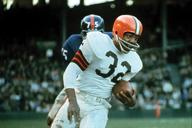 Jimmy Brown (32), running back for the Cleveland Browns, is shown in action against the New York Giants in Cleveland, Ohio, on Nov. 14, 1965.