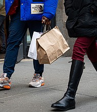 The US economy grew faster in the first quarter than previously estimated. A shopper carries bags in the SoHo neighborhood of New York, on January 21.
Mandatory Credit:	Jordana Bermudez/Bloomberg/Getty Images