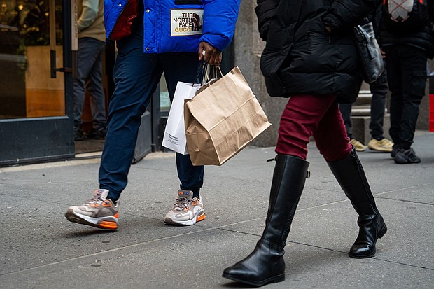 The US economy grew faster in the first quarter than previously estimated. A shopper carries bags in the SoHo neighborhood of New York, on January 21.
Mandatory Credit:	Jordana Bermudez/Bloomberg/Getty Images