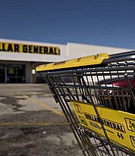 Following repeated violent incidents and federal workplace safety violations at stores, some Dollar General workers and labor advocates are calling for stronger safety and health protections. A shopping cart sits in a parking lot outside a Dollar General store in Moline, Illinois, in 2015.
Mandatory Credit:	Daniel Acker/Bloomberg/Getty Images/FILE