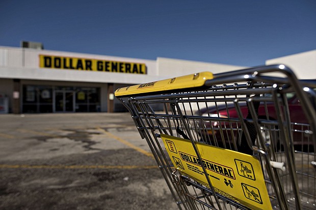 Following repeated violent incidents and federal workplace safety violations at stores, some Dollar General workers and labor advocates are calling for stronger safety and health protections. A shopping cart sits in a parking lot outside a Dollar General store in Moline, Illinois, in 2015.
Mandatory Credit:	Daniel Acker/Bloomberg/Getty Images/FILE