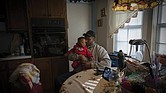 James Lyons kisses his grandson, Adrien Lyons, in the kitchen of his home in Birmingham, Ala., on Saturday, Feb. 5, 2022.