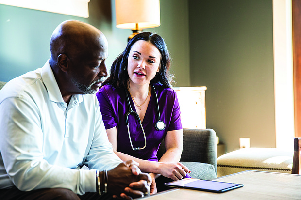 Photo courtesy of Getty Images (man talking with nurse)