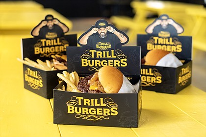 Trill Burgers OG Burger and Trill Burgers Vegan OG Burger - OG Burger is an all-beef patties with pickles, caramelized onions, American cheese, and Trill sauce; Vegan OG Burger is a vegan patty with vegan cheese and vegan mayo - single and triple patties are available