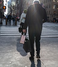 People walk along 5th Avenue in Manhattan, one of the nation's premier shopping streets on February 15, in New York City.
Mandatory Credit:	Spencer Platt/Getty Images