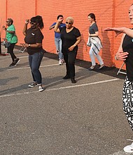 Meanwhile, zumba instructor Sam Minns leads a high-paced Zumba class during the Robinson Theater Block Party.