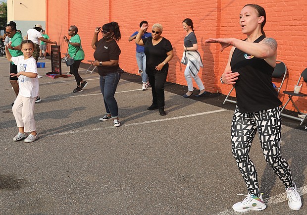 Meanwhile, zumba instructor Sam Minns leads a high-paced Zumba class during the Robinson Theater Block Party.