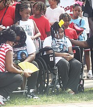 Tameeka Jackson-Smith, seated left, is consoled by supporters as she mourns the deaths of her son, Shawn Jackson, and husband Renzo Dell Smith, both of whom were killed by gunfire near Monroe Park shortly after Mr. Jackson ‘s Huguenot High School graduation on June 6. Mrs. Jackson-Smith, whose 9-year-old daughter Renyah Smith, center, was hit by a car after witnessing the murders of her father and brother, was consoled by her grandmother, Grenda Smith of Monroe, La., who is the mother of Mr. Smith.