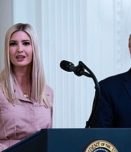 Former President Donald Trump (right) watches his daughter Ivanka Trump, address an event in the East Room of the White House on April 28, 2020.
Mandatory Credit:	Doug Mills/The New York Times/Redux