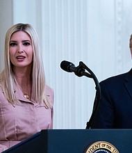 Former President Donald Trump (right) watches his daughter Ivanka Trump, address an event in the East Room of the White House on April 28, 2020.
Mandatory Credit:	Doug Mills/The New York Times/Redux