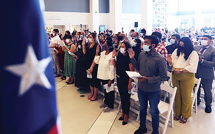 U.S. Court of Appeals for the Fourth Circuit Chief Judge Roger L. Gregory, administers the Oath of Allegiance to 46 people from 29 countries during a ceremony at the Virginia Museum of History & Culture Monday, July 4, 2022.