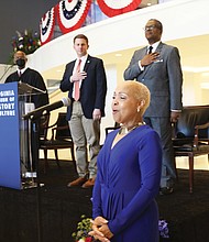Dr. Lisa Edward-Burrs sings The National Anthem at beginning of a ceremony honoring new citizens at the Virginia Museum of History & Culture Monday, July 4, 2022.