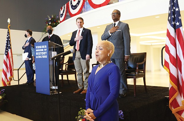 Dr. Lisa Edward-Burrs sings The National Anthem at beginning of a ceremony honoring new citizens at the Virginia Museum of History & Culture Monday, July 4, 2022.