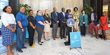Saraya Perry, far left, program officer for the Health Equity Fund, stands with the latest HEF partners on Tuesday in Richmond City Hall Tuesday afternoon. They are joined by Mayor Levar M. Stoney (sixth from right) and Richmond City Council President Michael Jones (seventh from right).