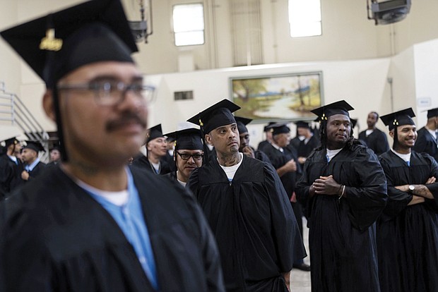 Incarcerated graduates, who finished various educational and vocational programs in prison, wait for the start of their graduation ceremony at Folsom State Prison in Folsom, Calif., Thursday, May 25. Thousands of prisoners throughout the United States get their college degrees behind bars, most of them paid for by the federal Pell Grant program, which offers the neediest undergraduates tuition aid that they don’t have to repay.
That program is about to expand exponentially next month, giving about 30,000 more students behind bars some $130 million in financial aid per year.